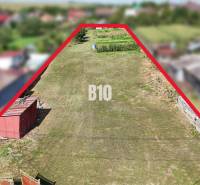 Land for housing in Rumanová with a focus on grassy area and construction.