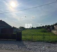 Plots - housing in Rumanová with a sunny view of a green grassy area.