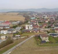 Aerial view of a residential area in Rosina with houses and greenery. Plots - housing.