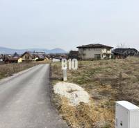 Land - housing in Rosina, a peaceful location with views of the surrounding houses and nature.
