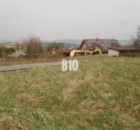 Plots - housing in the village of Rosina, grassy land with the surroundings of rural houses.