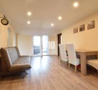 Living room in a family house with a sofa and a dining table.