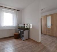 Interior of a family house with an aquarium, a wardrobe, and a wooden floor.