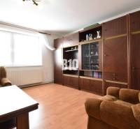 Living room in a family house with a seating set and a wooden wall unit.