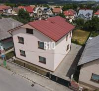 A family house in Bytča with a sloped roof and a yard in a built-up area.