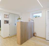 Interior of a family house with a spacious room, reception, and floor with wooden decor.