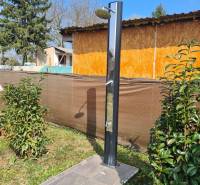 Garden shower by the cottage in Štúrovo on a grassy plot with a paved surface.