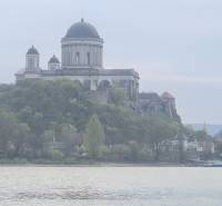 Basilica on a hill by the river in the town of Štúrovo, surrounded by greenery.