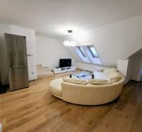 Living room in a 3-room apartment with a beige sofa and a wooden decor floor.
