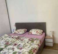 Bedroom in a 3-room apartment with a bed and floral bedding on the bed.