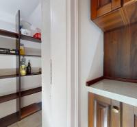 Storage space with shelves and a cabinet with wooden decor in a 5 or more room apartment.
