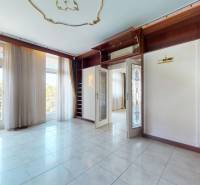 A room with large windows and built-in shelves in a 5 or more room apartment.