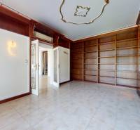 A library with spacious shelves and ceramic tiles in a 5 or more room apartment.