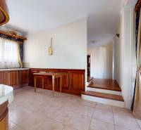 A kitchen in a 5 or more room apartment with wooden decor and curtains.