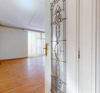 Interior of a 5 or more room apartment with white doors and a floor with a wood decor.