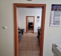 Office spaces with tiles, wooden door frames, and wall clocks in warehouses and halls.