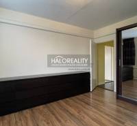 A room with a wooden decor floor, a mirrored wardrobe, and a chest of drawers in a 3-room apartment.