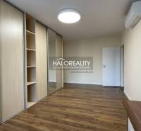 Interior of a 3-room apartment with a wooden decor floor and a built-in wardrobe.