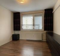 A room in a 3-room apartment with a wooden decor floor and white walls.