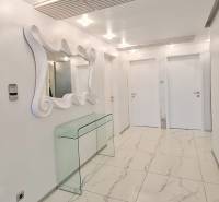 Elegant hallway in a 3-room apartment with marble cladding and a mirror.