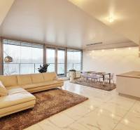 Spacious living area with a cream sofa in a 3-room apartment and glossy floor.