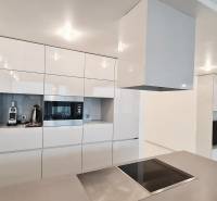 A kitchen in a 3-room apartment with white cabinets and built-in appliances.