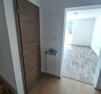 Interior of a family house with doors, a radiator, and a wooden decor floor.