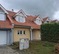 A family house in Ľubela with a red roof, a garage, and a well-maintained garden.