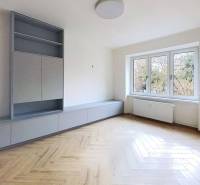A bright living space with wood-decor flooring in a 2-room apartment.