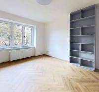 A bright room with a shelving cabinet and a wooden decor floor in a 2-room apartment.