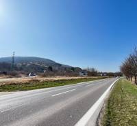 Road by the plots in Bratislava - Devínska Nová Ves with a view of the hills.