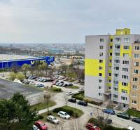 Apartment building on Sofijska Street in the Ťahanovce Housing Estate district, Košice, with a parking lot and a view.
