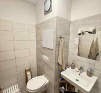 Bathroom in a 2-room apartment with ceramic tiles and sanitary ware.