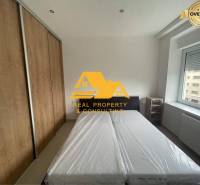 Bedroom in a 3-room apartment with a bed, built-in wardrobe, and a window with a view.