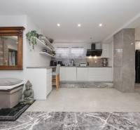 A kitchen in a family house with decorations, kitchen unit, and seating.