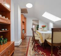 A dining room in a family house with wooden furniture and a floor with a wooden decor.