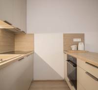 A kitchen unit with a wooden decor floor in a 3-room apartment.