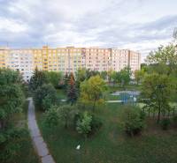 A large apartment building surrounded by trees and well-maintained walkways on Krakovská in Košice.