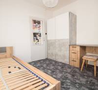 Bedroom in a 4-room apartment with a bed, a desk, and a wardrobe.