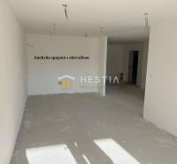 An empty living room connected to the kitchen, suitable for furnishing a 2-room apartment.