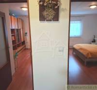 Interior of a family house with a wooden decor floor, bedroom, and storage space.