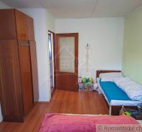 Children's room in a family house with a wooden decor floor and toys.