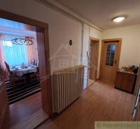 A hallway with a wooden decor floor in a family house, cozy furniture arrangement.