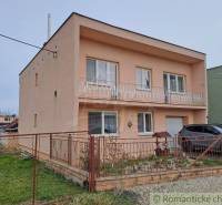 A family house in Veľké Ripňany with a balcony and a landscaped yard.