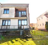 A family house in Žilina with a terrace, lawn, and stairs leading to the garden.