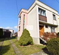 A family house in Žilina with a garage, garden, and driveway in a quiet neighborhood.