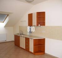 Attic kitchen with kitchen unit, tiles, and skylight ideal for offices.