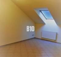 An attic room with a skylight and tiles, suitable for offices.