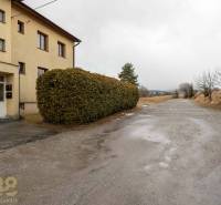Exterior of a 5 or more bedroom apartment in Stará Lesná with visible bushes and a road.