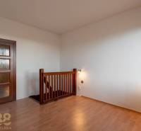 Interior of a 5 or more room apartment with wood-patterned flooring and a staircase.